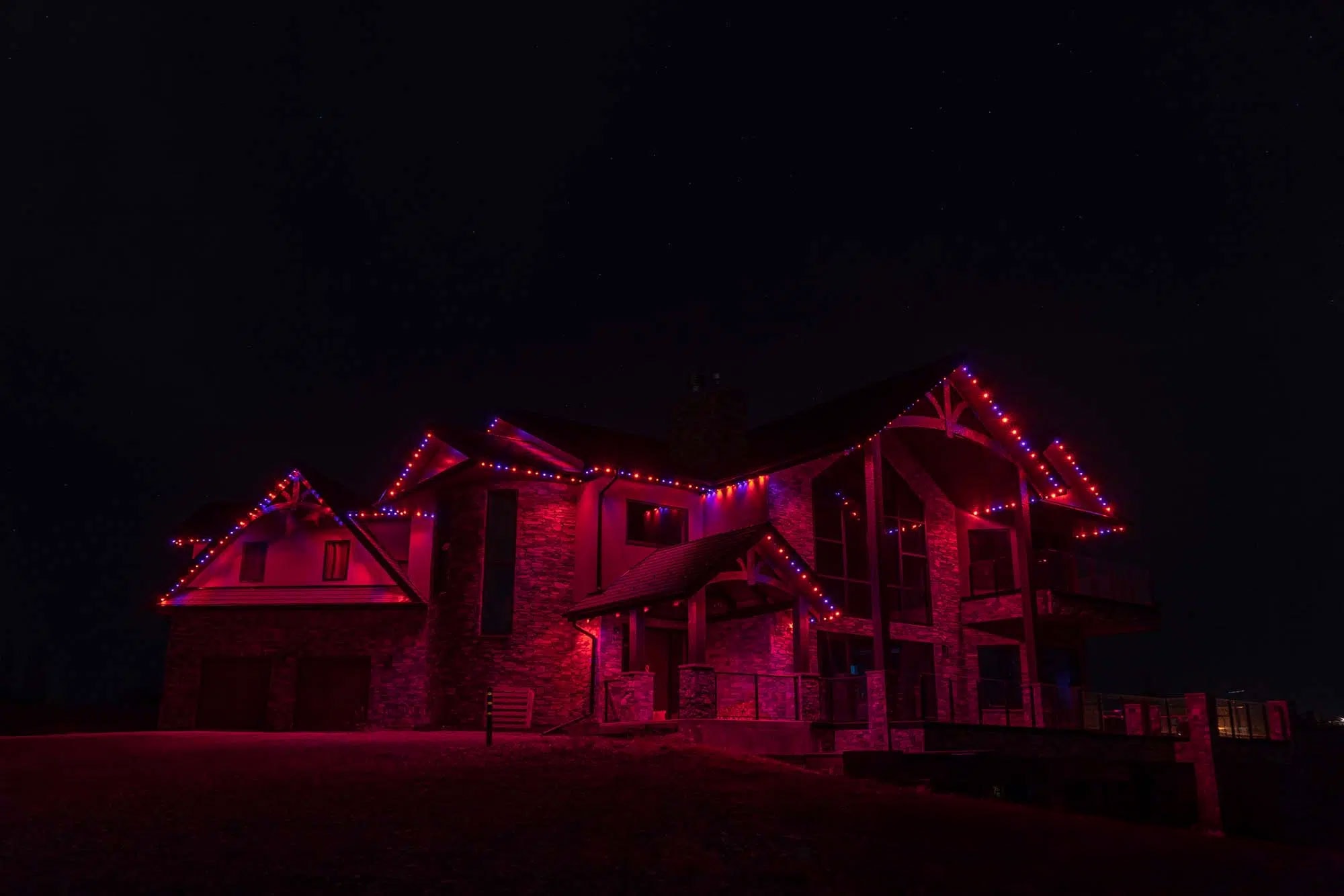 Dramatic home with red and pink architectural lighting